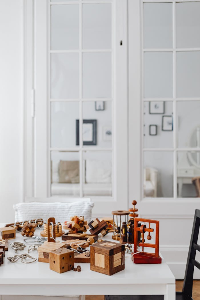 Collection of wooden puzzle toys on a white table in a modern indoor setting.